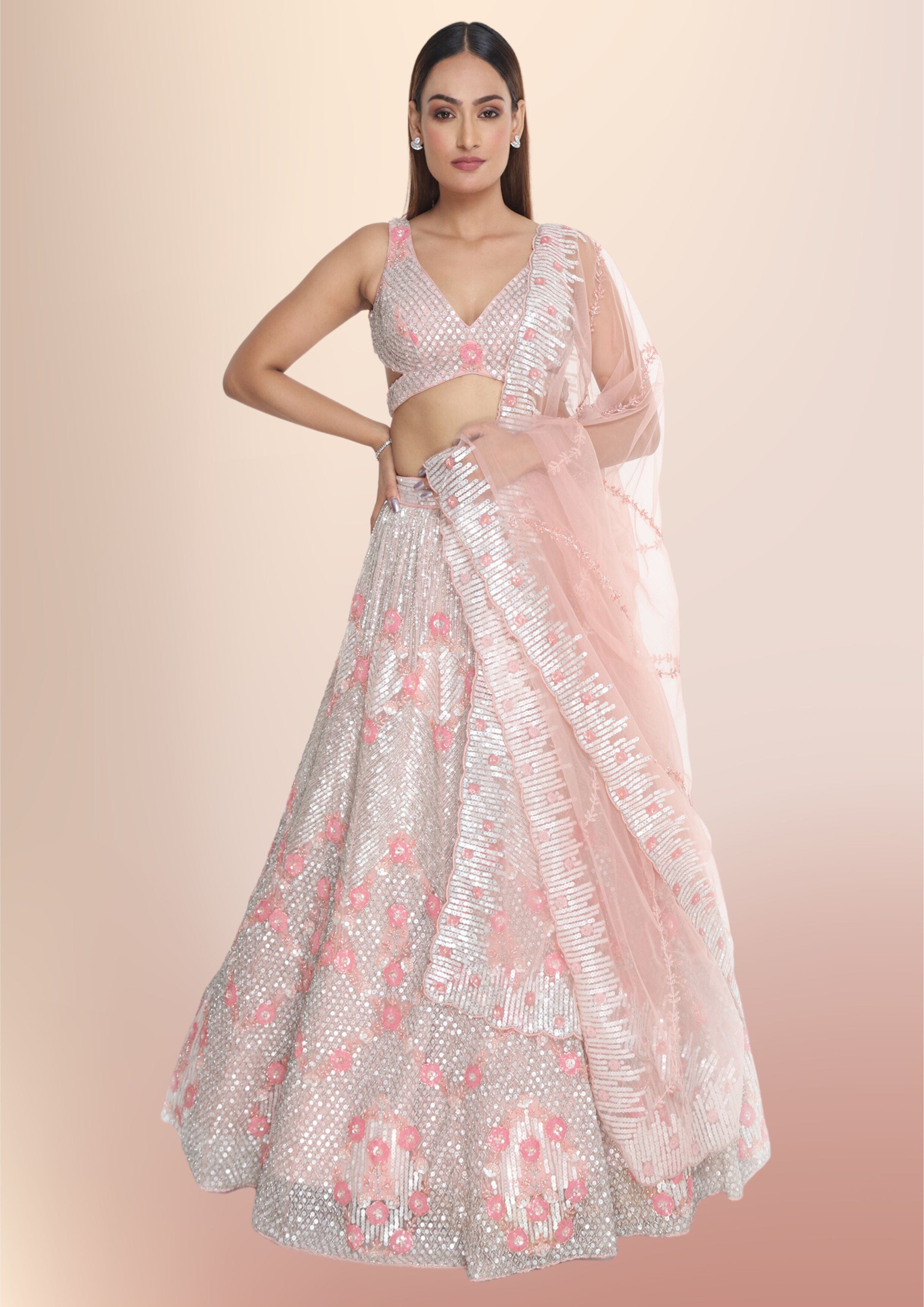BABY PINK SHIMMERY COCKTAIL LEHENGA SET WITH A HAND EMBROIDERED MIRROR WORK  BLOUSE PAIRED WITH A MATCHING DUPATTA AND FRILL DETAILS. - Seasons India
